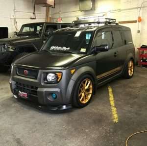 Black honda element gold wheels graphics red emblem civic front lip fog lights roof basket rack slammed lowered