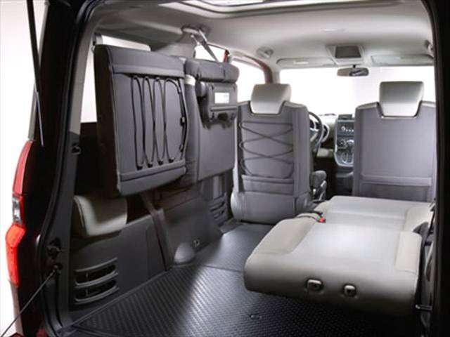 honda element interior configuration rear passneger seat folded laying back while backseat drivers side is mounted up against the wall